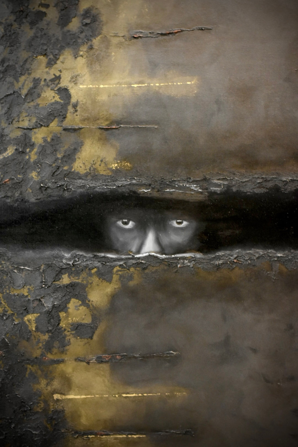An abstract textured artwork featuring a pair of white eyes peering through a dark horizontal fissure, surrounded by layered charcoal, gray, black, and metallic gold tones.