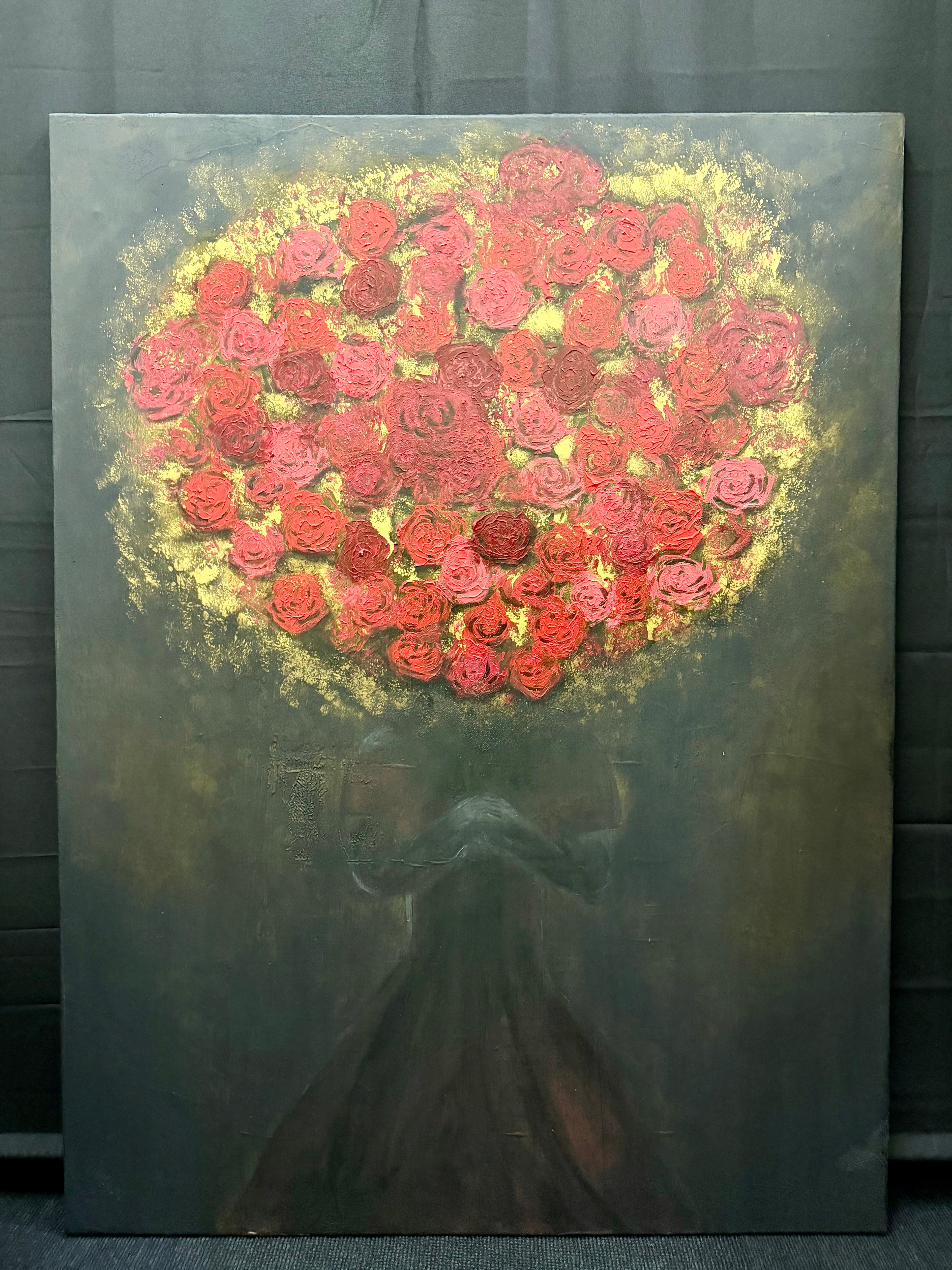 A vertical canvas painting featuring a large bouquet of red and pink roses forming a heart shape, with a dark, shadowy female figure beneath it against a dark textured background.